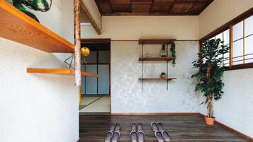 A wooden staircase with a tiled floor, wooden shelves, and a potted plant.