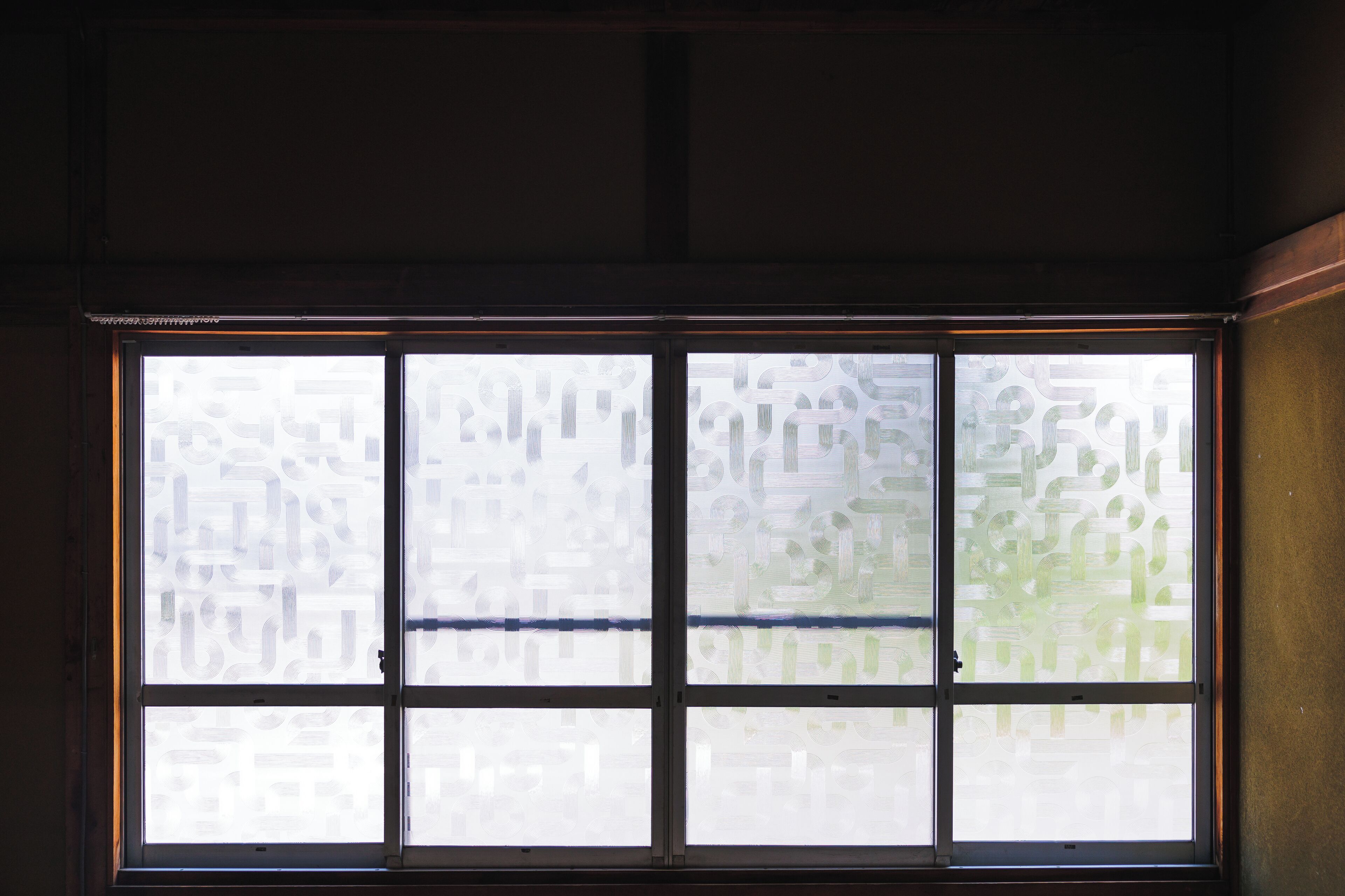 A window with frosted glass panes and a visible door handle.