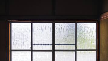 A window with frosted glass panes and a visible door handle.