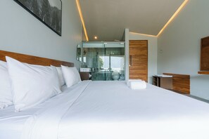 A modern hotel room with a large bed, a wooden headboard, a glass shower enclosure, and a view of the outdoors. - Noya Hotel (Kintamani)