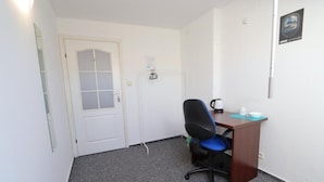 A small office with a desk, chair, and a door. - Fantastic Inn Warsaw - NS42 (Warsaw)