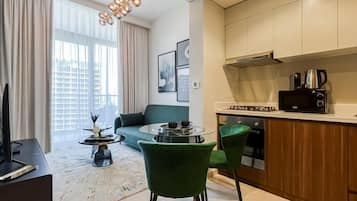 Deluxe Apartment, 1 Bedroom, Non Smoking | Living area | 65-inch flat-screen TV with satellite channels