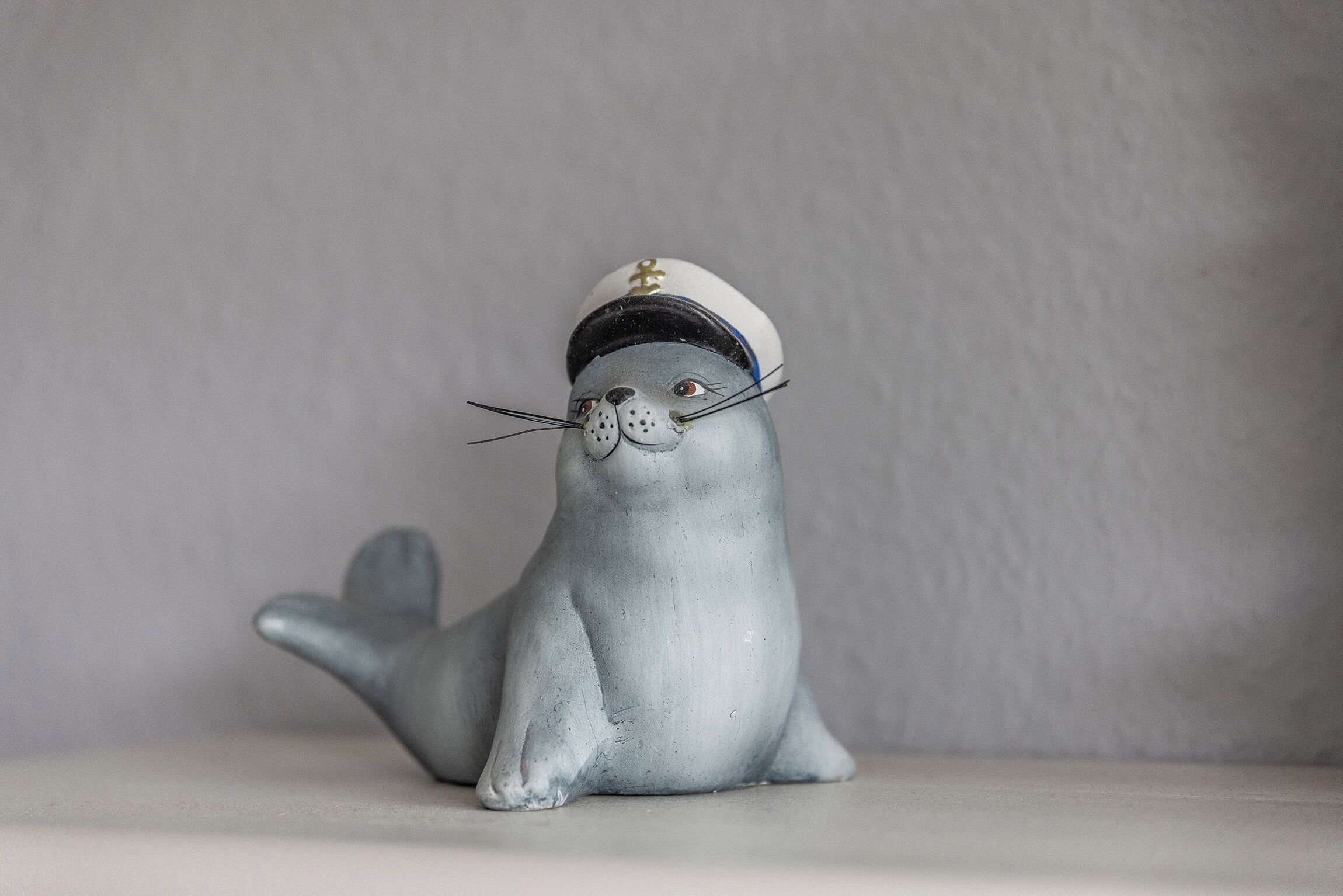 A figurine of a seal wearing a sailor's hat.