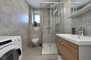 Shower, hair dryer, towels, toilet paper
