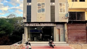A modern hotel with a flat facade, multiple windows, and a visible entrance. - Hotel Yaduraj By Salasar Hospitality (Udaipur)