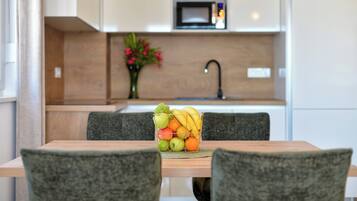 Deluxe Apartment, Balcony, Partial Sea View | In-room dining