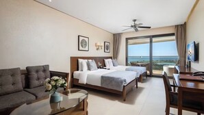 A hotel room with two beds, a sofa, a dining table, and a TV. - Qionghai Bozha Baiyuewan Zhenru Hotel (Qionghai)