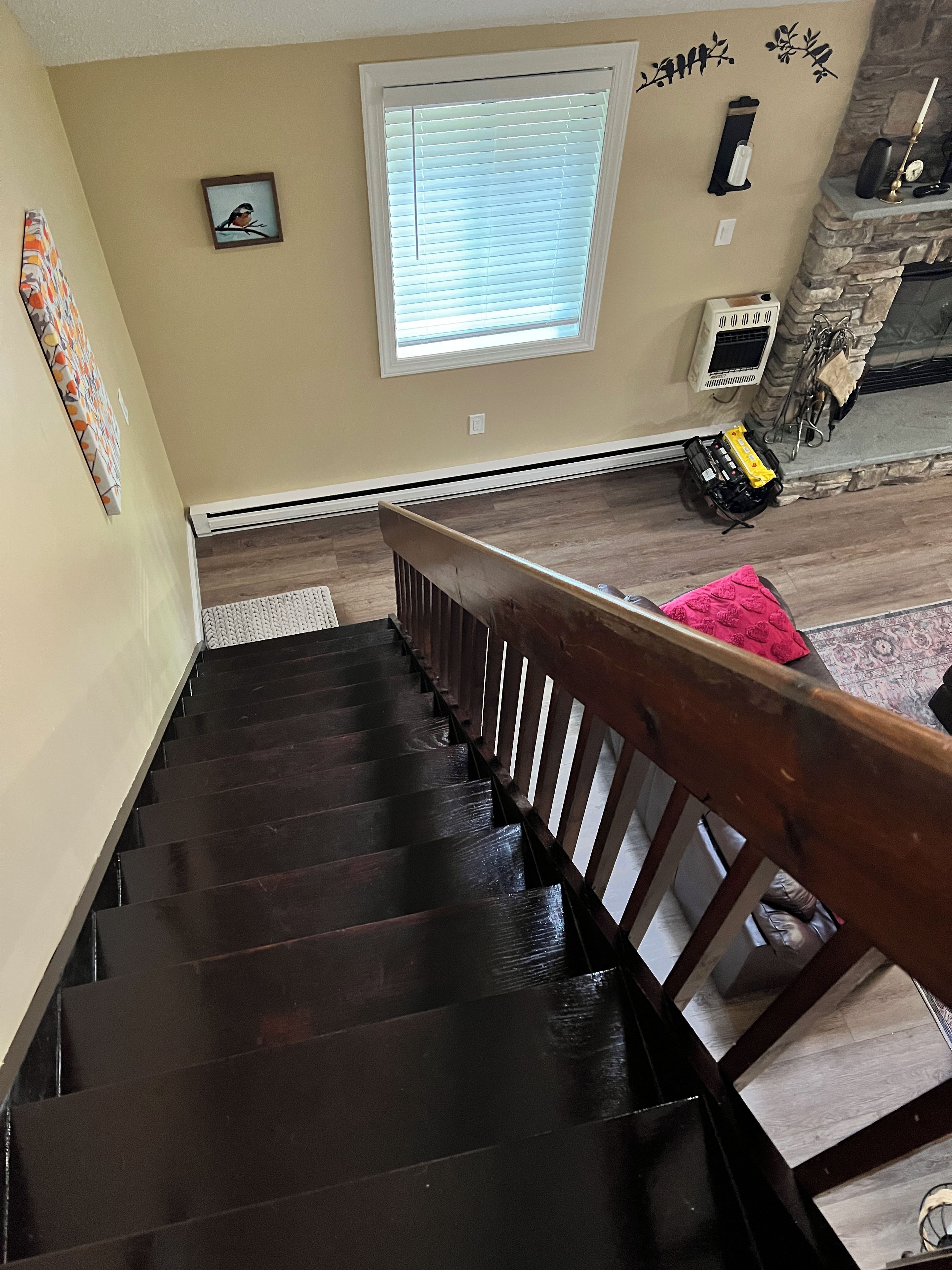A staircase with a wooden handrail leading to a landing.