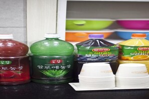 A variety of beverage containers and disposable cups on a counter. - Ari House (Seoul)