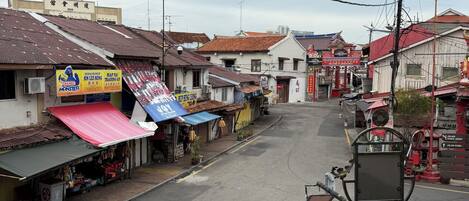 A street view with various shops and buildings, including a sign for 'KIRIN BISTRO' and a 'MONSTER' sign.