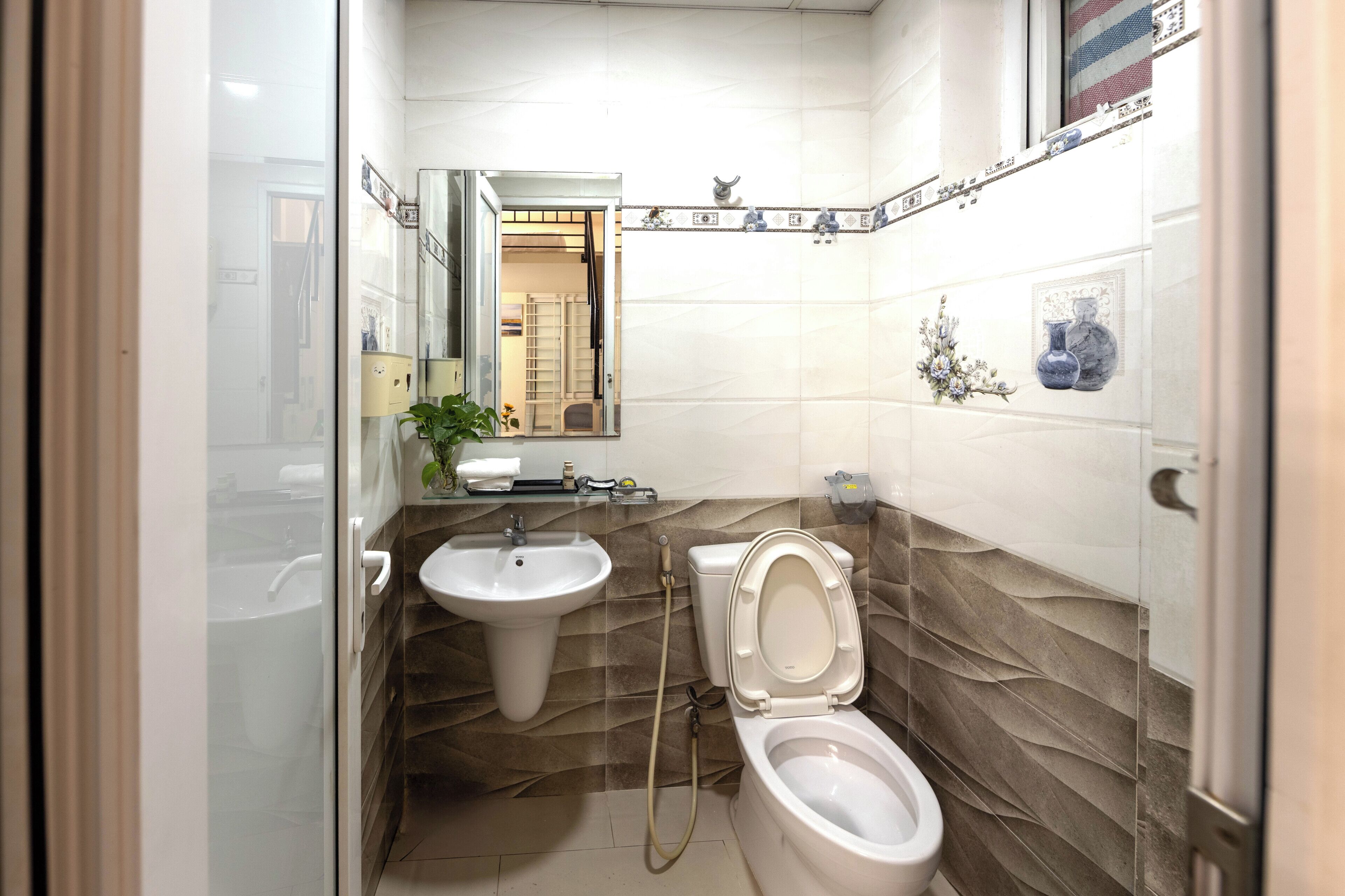 A bathroom with a sink, toilet, and shower.