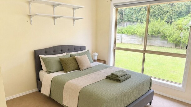 A bedroom with a bed, a window, and a view of the outdoors. - Relaxed Mount Gambier home with backyard (Mount Gambier)