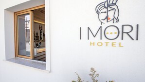 A hotel sign with a stylized face and the name "IMORI HOTEL". - I Mori Hotel  (San Vito Lo Capo)