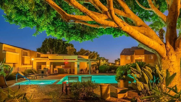 A pool area with a lounge chair, a small pool, and a building with a sign that reads "Lounge". - Starlight Escape - Heated Pool & Spa by Old Town! (Scottsdale)