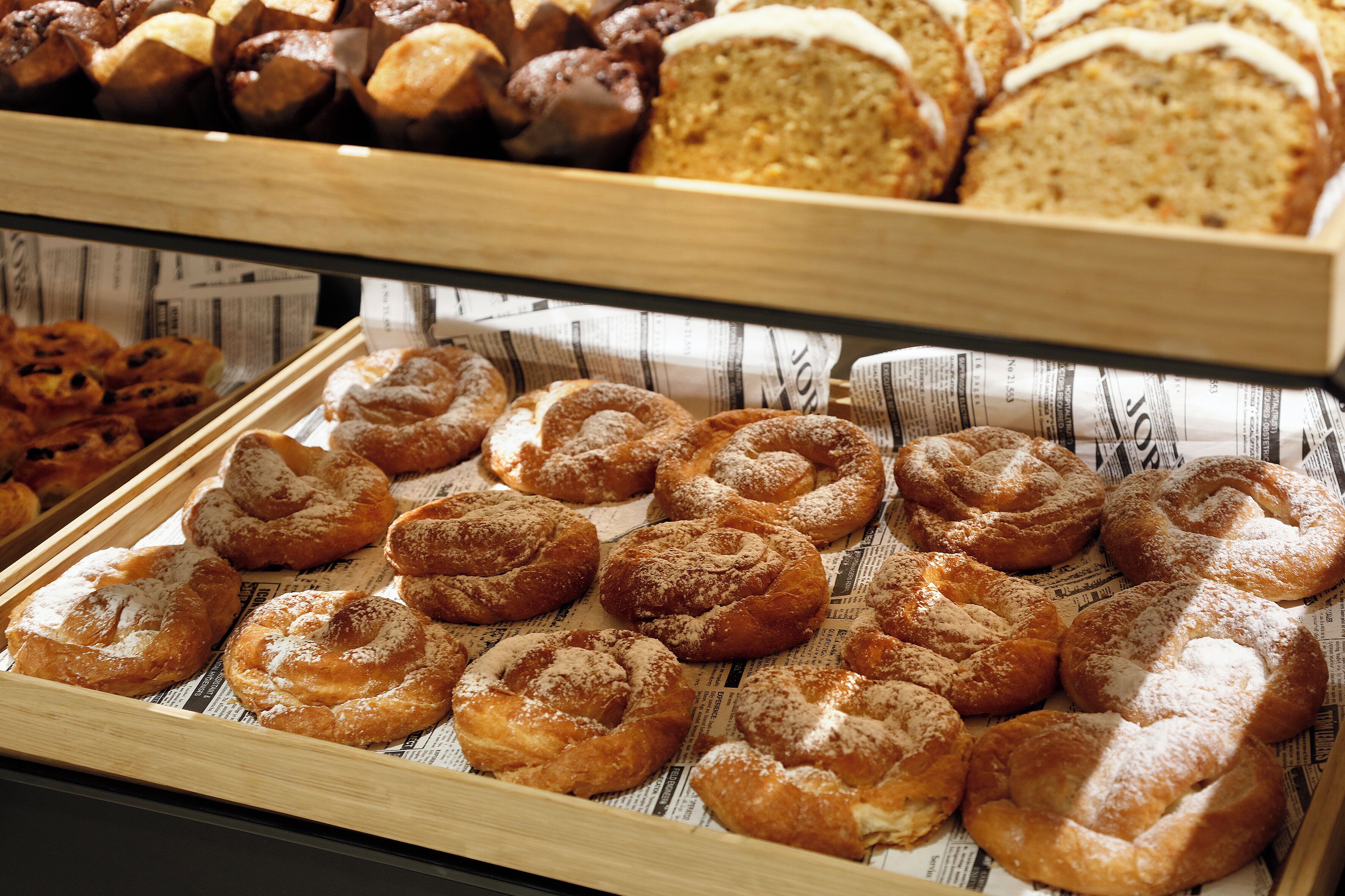 A bakery display with various baked goods.