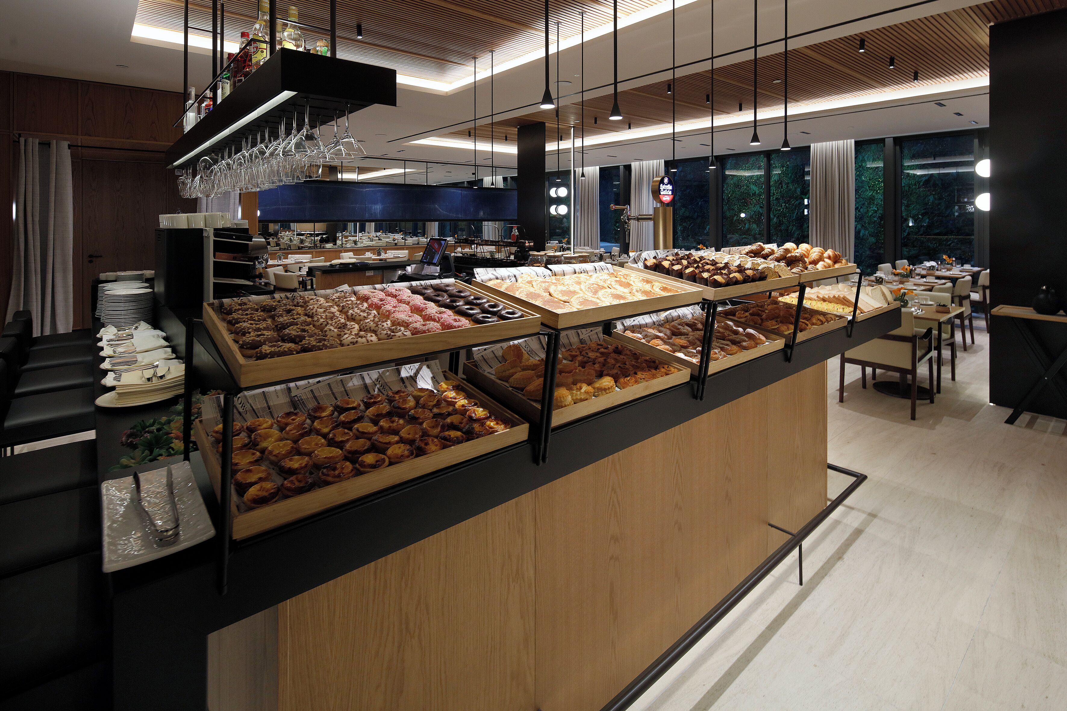 A buffet with various food items, a bar area, and a seating area with tables and chairs.