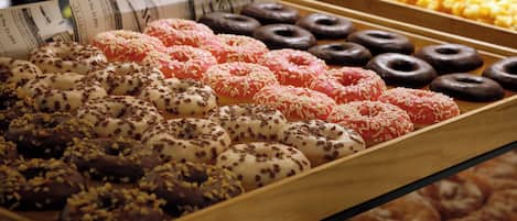 A display of assorted donuts with various toppings and glazes.