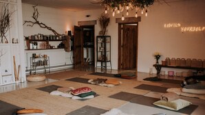 A cozy room with a checkered floor, a bookshelf, a radiator, and a neon sign. - 1. The Owl's Look Out, Patty's Barn, Lancaster 4* (Lancaster)