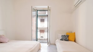 A hotel room with two beds, a balcony, and an air conditioning unit. - Rifugio Pugliese by Wonderful Italy (Bari)