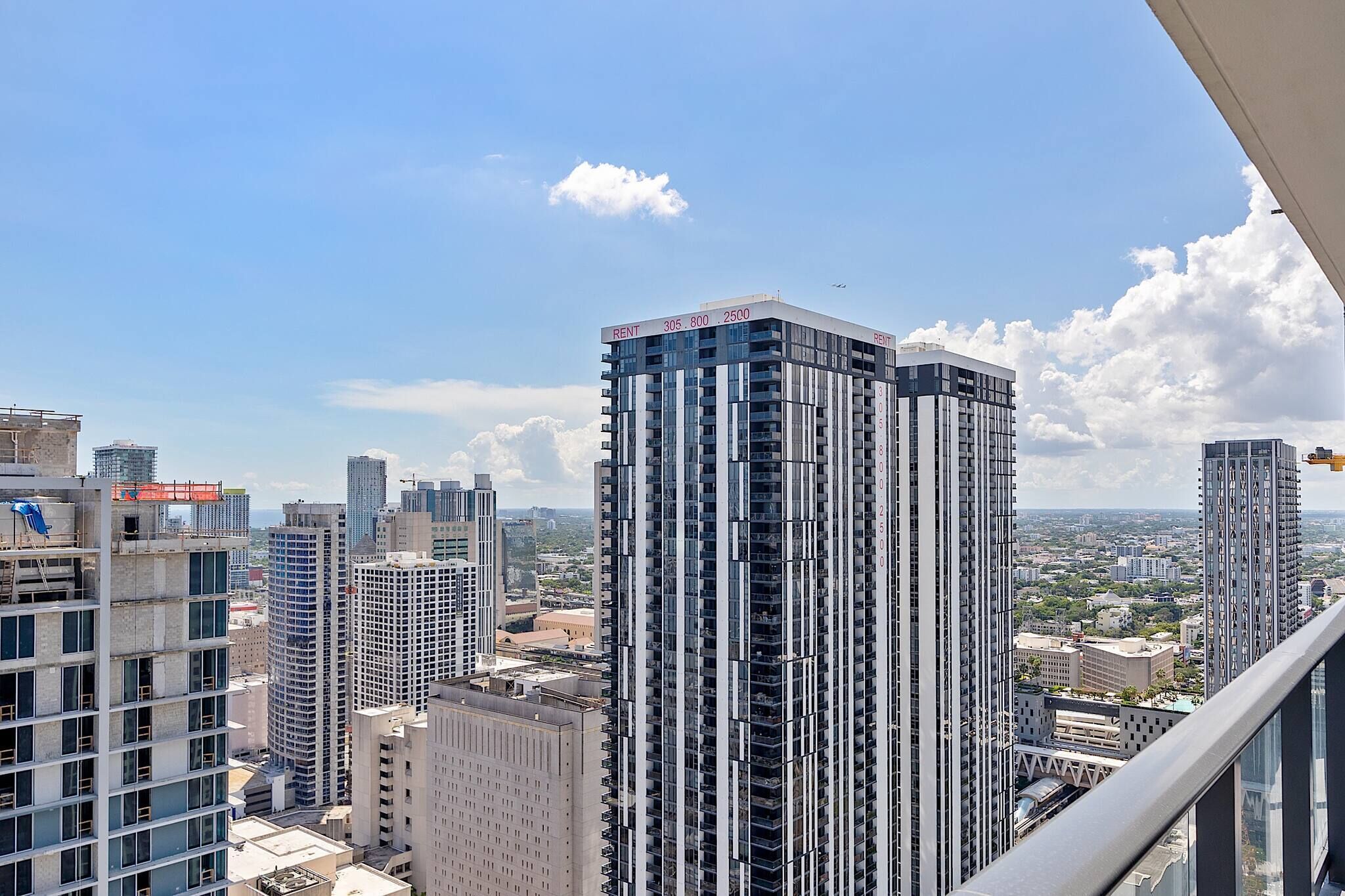 A high-rise building with multiple floors, large windows, and a clear view of the cityscape.