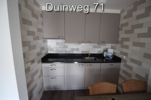 Fridge, stovetop, dishwasher, coffee/tea maker