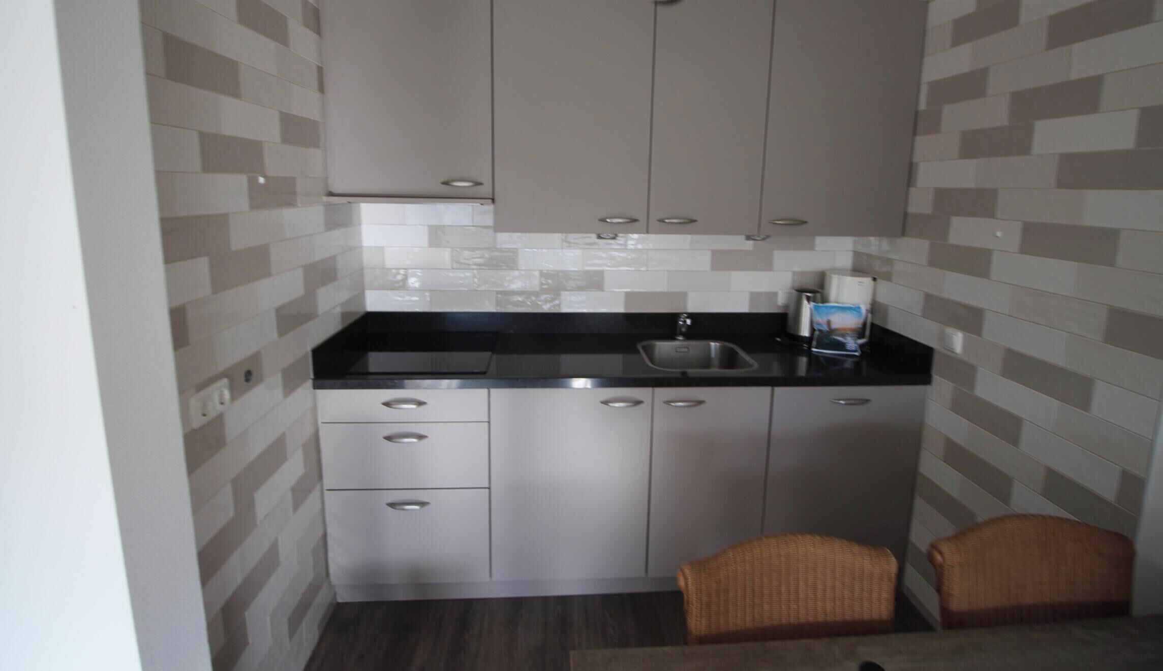 Fridge, stovetop, dishwasher, coffee/tea maker