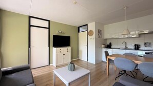A modern apartment with a living area, kitchenette, and a dining space. - 3 bedroom accommodation in Westkapelle (Westkapelle)