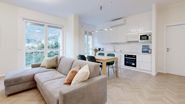 Un apartamento moderno con sala de estar, comedor y cocina.
