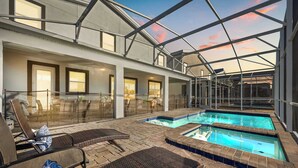 A rooftop pool area with lounge chairs and a glass-enclosed structure. - Enchanting 7BR Disney  Villa Private Pool  Oasis (Davenport)