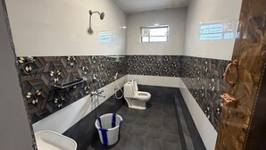 A bathroom with a modern design, featuring a toilet, sink, and shower. - Glass House Retreat (Valparai)