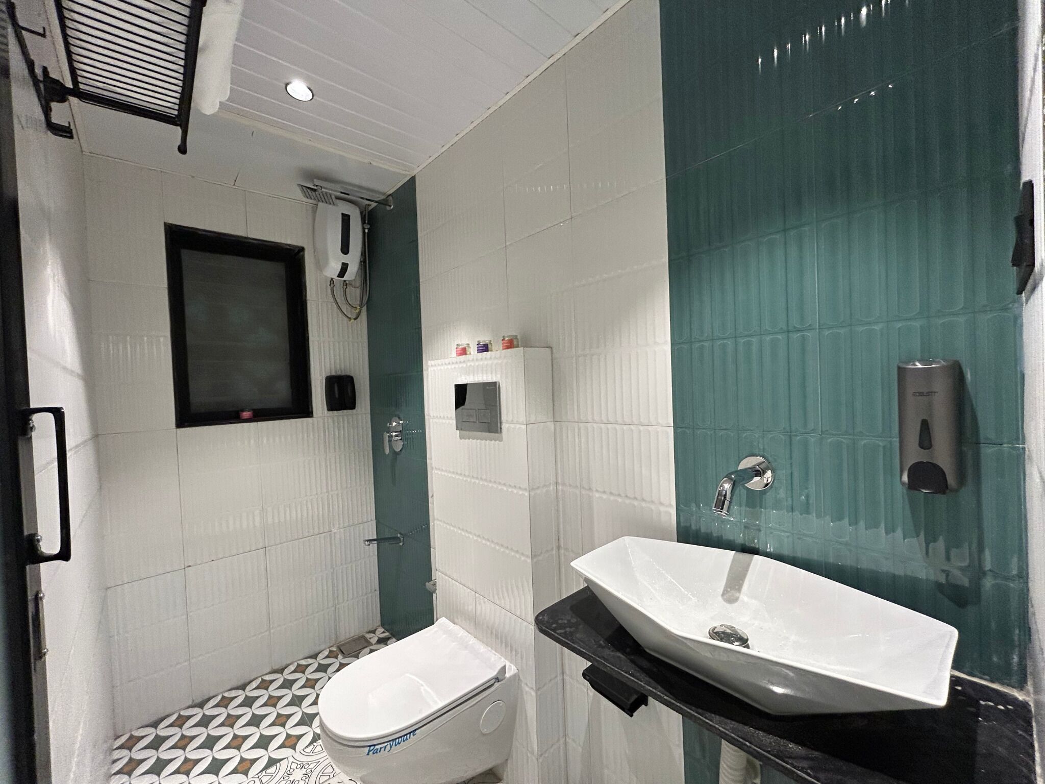 A bathroom with a white toilet, a sink, and a shower area.
