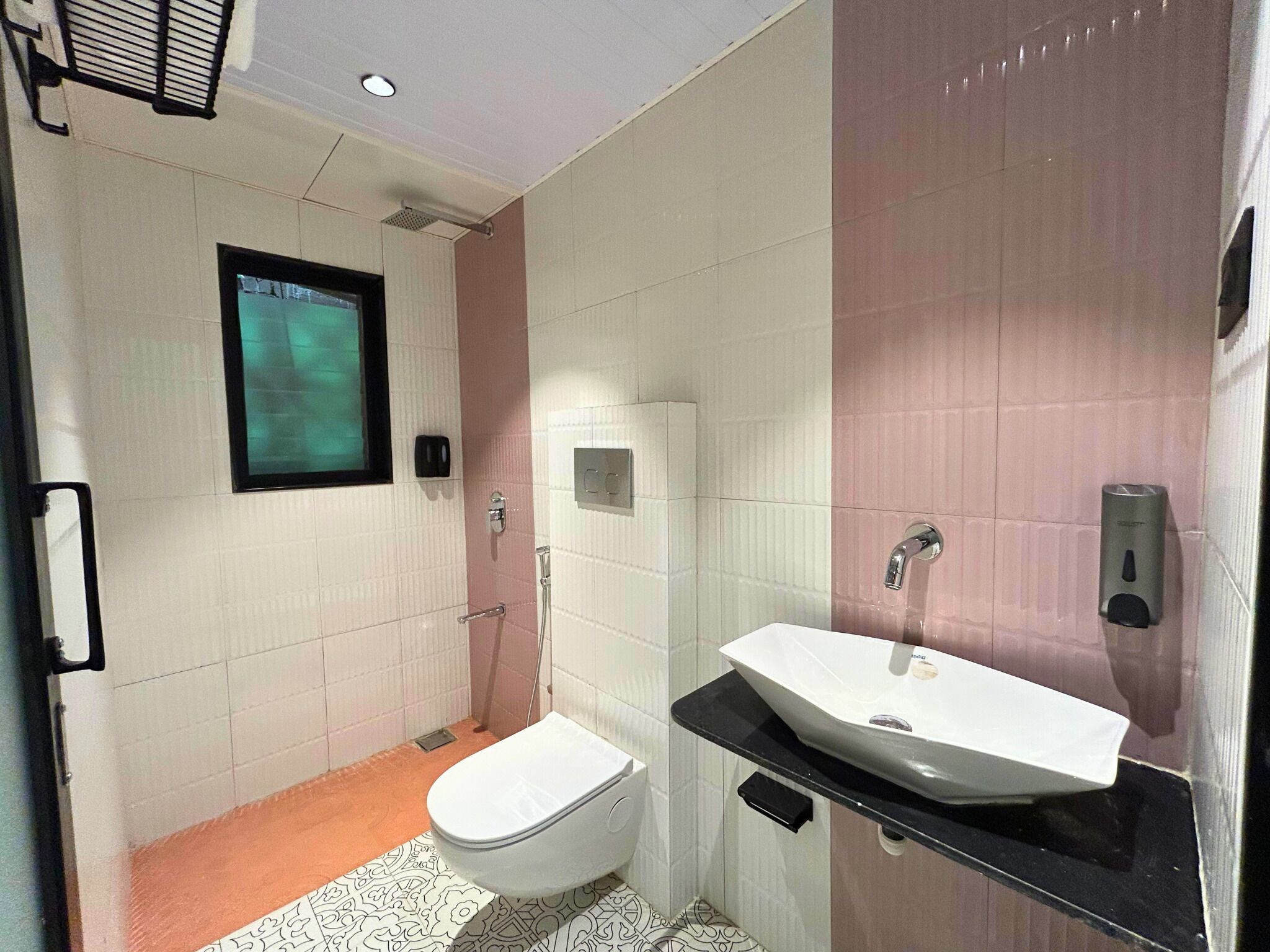 A modern bathroom with a toilet, bidet, and sink.
