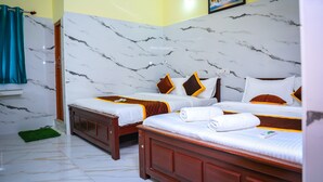 A hotel room with two beds, marble walls, and a painting on the wall. - RR RESIDENCY RANIPET (Walajapet)