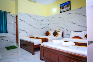 Habitación cuádruple Deluxe | Ropa de cama