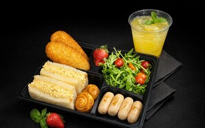 A meal tray with bread, croissants, sausages, a salad, strawberries, and a drink. - UHF HOTELS & RESORTS PINETREE (Iskandar Puteri)