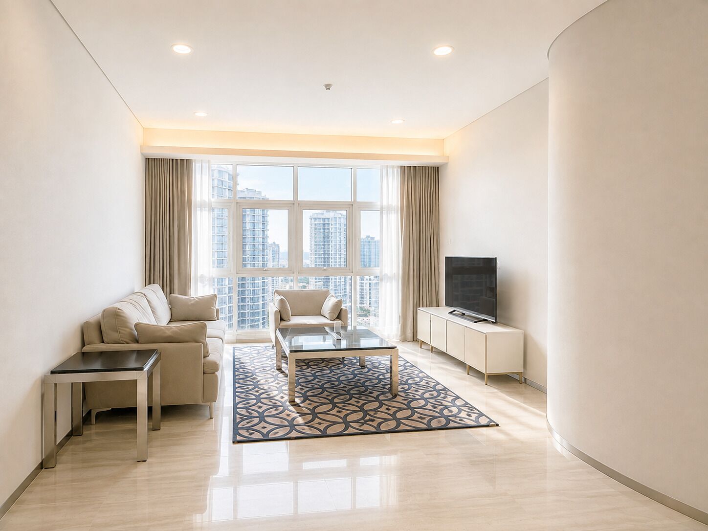 A modern living room with a sofa, armchair, coffee table, and TV.