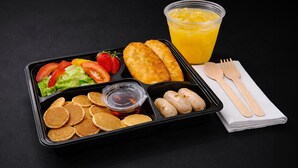 A meal tray with pancakes, sausages, salad, strawberries, and a glass of orange juice. - UHF HOTELS & RESORTS PINETREE (Iskandar Puteri)