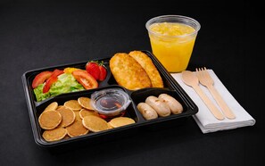 A meal tray with pancakes, sausages, salad, strawberries, and a glass of orange juice. - UHF HOTELS & RESORTS PINETREE (Iskandar Puteri)