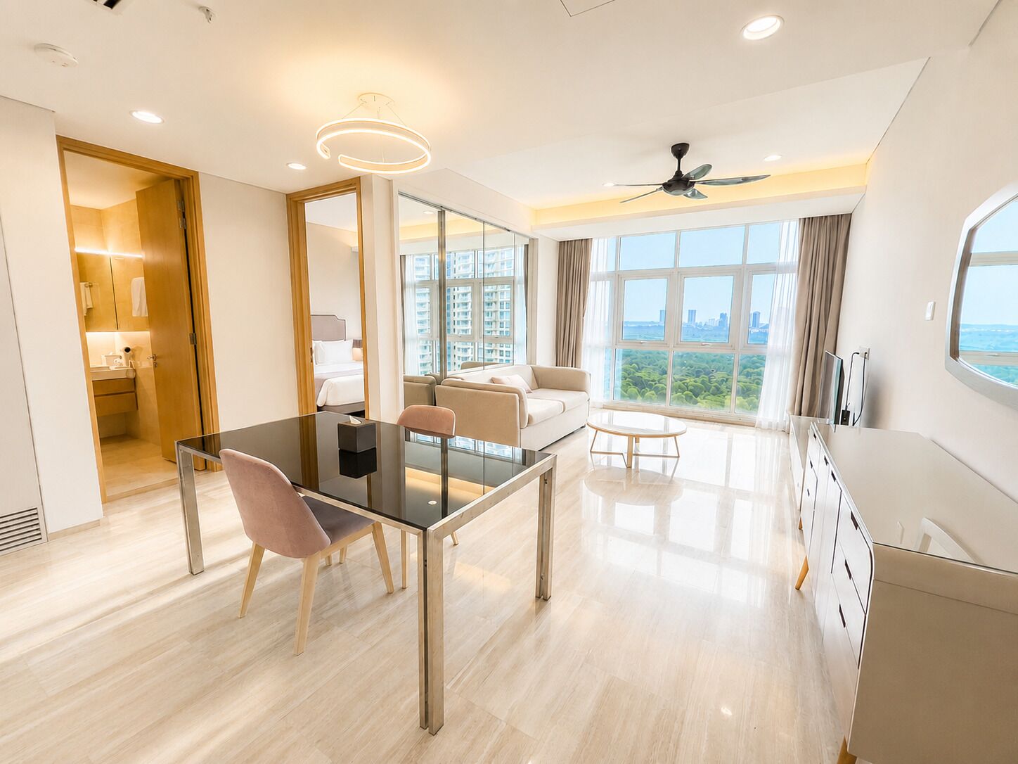 A modern hotel room with a dining area, a bed with a city view, and a balcony.