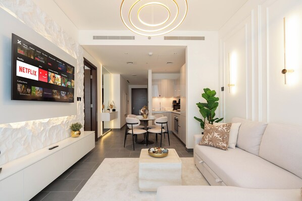 Deluxe Apartment, City View | Living area | 150-inch Smart TV with satellite channels, Netflix, streaming services