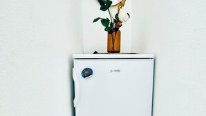 A white refrigerator with a sticker that reads 'gorenje' and a small globe sticker on the door. - Comfortable and Affordable Palace Studio (Vienna)