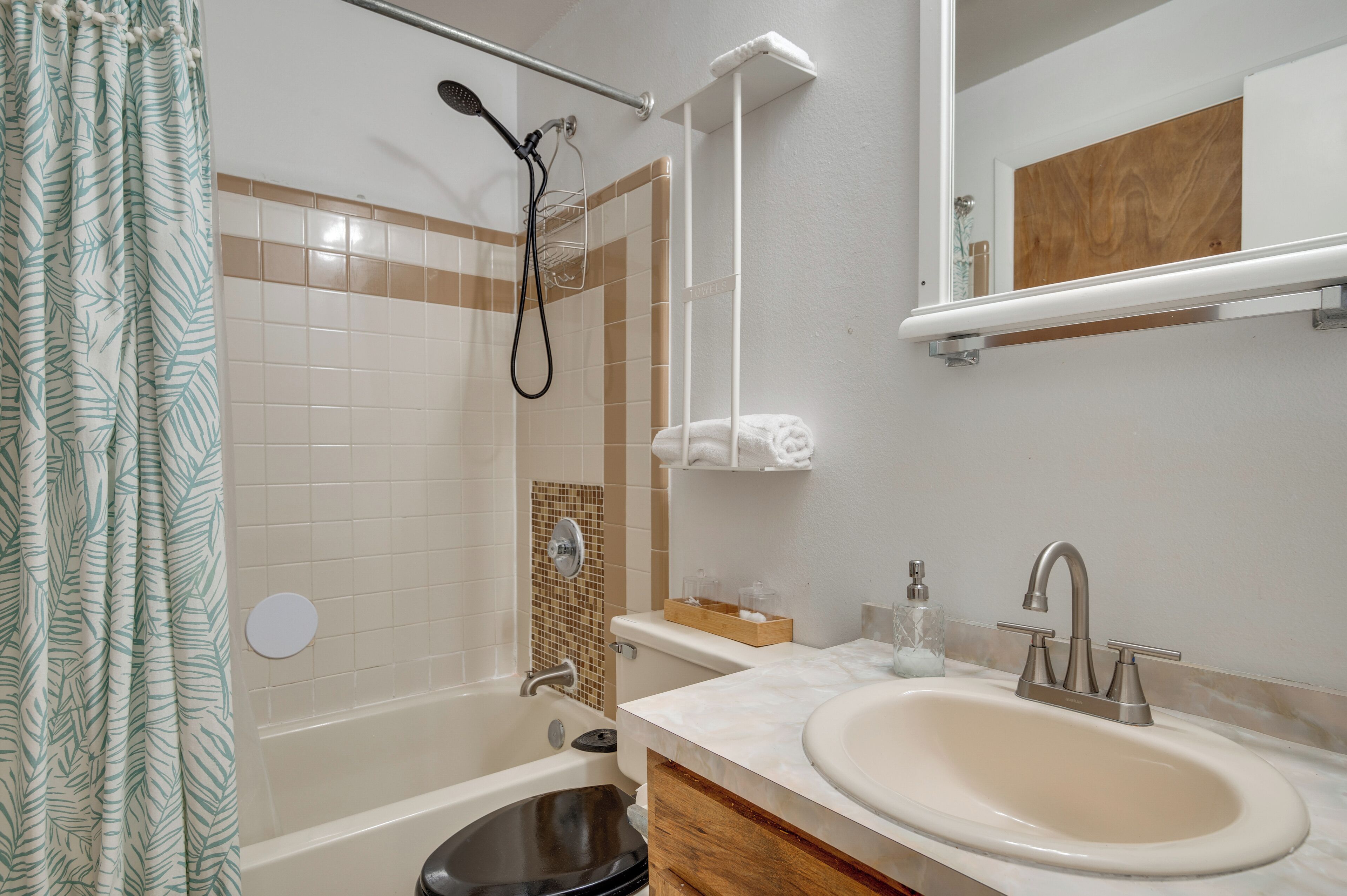 A bathroom with a bathtub, a sink, a shower, and a toilet.