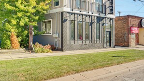 A two-story building with large windows, a balcony, and a brick facade. - 7 Mi to Dtwn & Lake Erie: Sleek Cleveland Apt! (Cleveland)