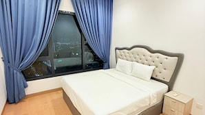 A bedroom with a bed, a nightstand, a ceiling fan, and a window with curtains. - LUCENTIA RESIDENCE BY HORIZON HOME (Kuala Lumpur)