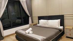 A neatly made bed with white pillows and a brown bedspread, a wooden nightstand with a drawer, and a window with curtains. - LUCENTIA RESIDENCE BY HORIZON HOME (Kuala Lumpur)