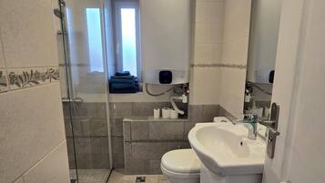 Shower, hair dryer, towels, toilet paper