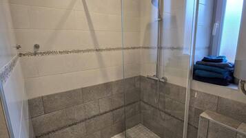 Shower, hair dryer, towels, toilet paper