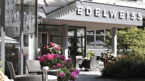 A restaurant named 'Edelweiss' with outdoor seating and potted plants. - Hotel Edelweiss (Gerlos)