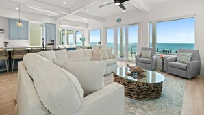 A spacious living area with a large sofa, a coffee table, and a view of the ocean. - NEW Rental!!! Viviana 11 - Private Pool Beach Front Home - Sleeps 14 (Perdido Key)
