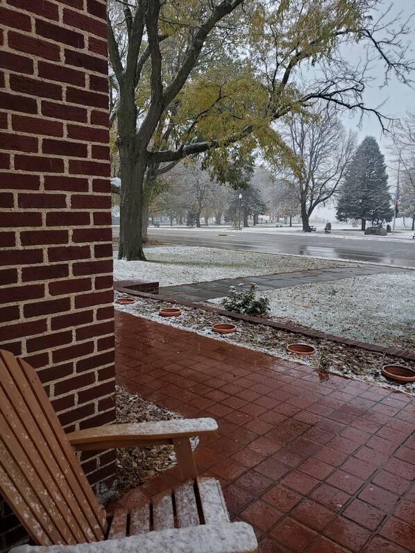 A brick building with a bench outside.